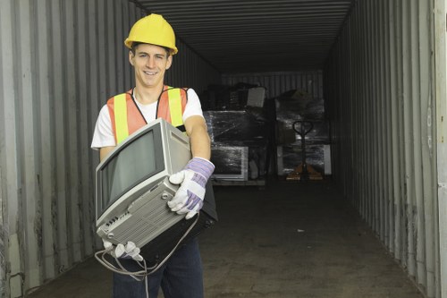 Workers efficiently clearing items from a loft space